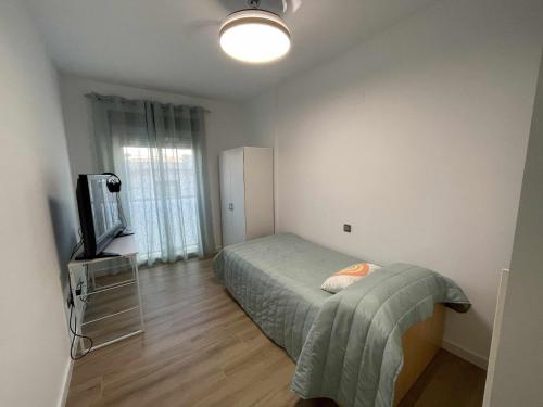 En eller flere senge i et værelse på Clauadris Home ideal para familias