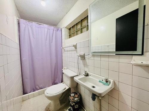 a bathroom with a toilet and a sink at La Candelaria in Bogotá