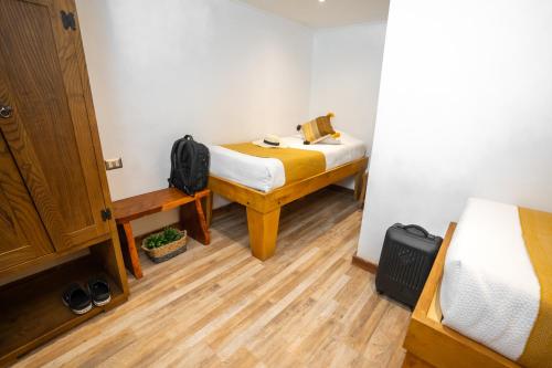 a small room with a bed and a desk and a bed sidx sidx at Hotel Don Raul in San Pedro de Atacama