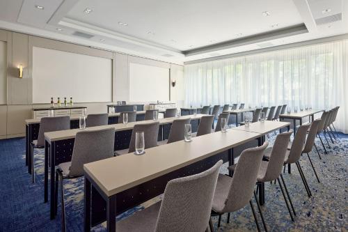 a large room with rows of tables and chairs at The Westin Grand Frankfurt in Frankfurt/Main