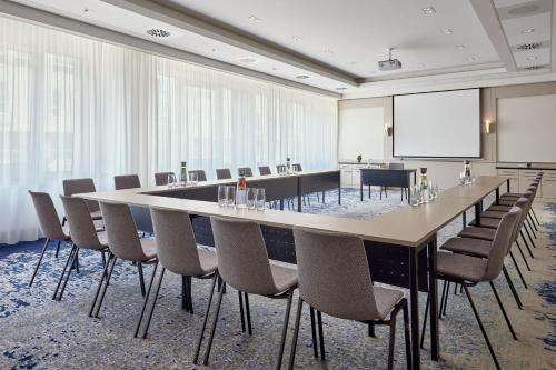 a conference room with a large table and chairs at The Westin Grand Frankfurt in Frankfurt/Main