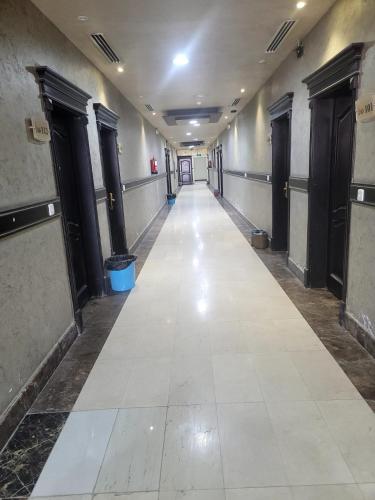 an empty hallway of a building with a long corridor at Quiet Rooms 8 in Riyadh
