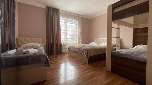 a bedroom with two beds and a mirror at Cottage in Bakuriani