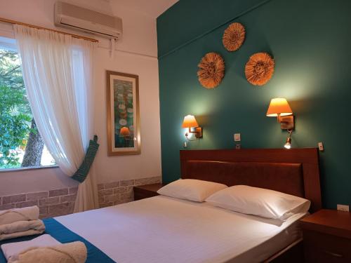 een slaapkamer met 2 bedden en een groene muur bij Castello Verde Apartments Studios in Plakias