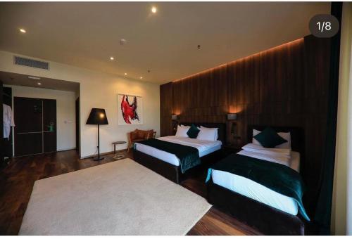 a hotel room with two beds in a room at Premium Park Hotel in Prizren