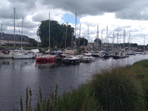 a bunch of boats are docked in a harbor at chambre carentan les marais aux calme très reposant in Saint-Hilaire-Petitville