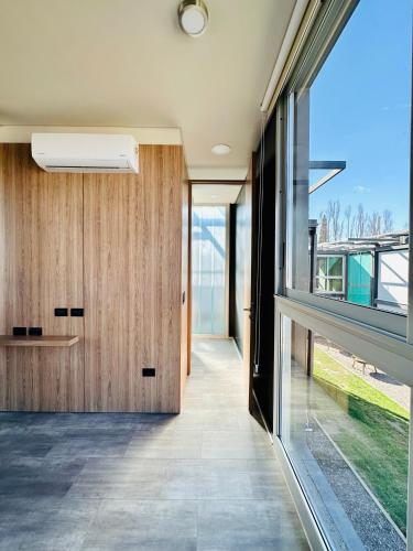 a hallway of a house with a large window at Cubos de Chacras AZUL in Mendoza
