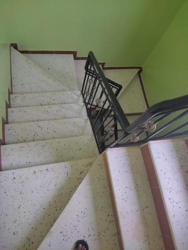 a set of stairs with a person standing on it at REPOS SURF HOUSE 2 in Sidi Ifni