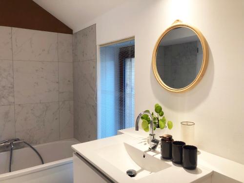 a bathroom with a sink and a mirror at Le pré de Régine et Joseph in Malmedy