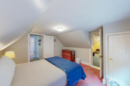 a bedroom with a bed with a blue blanket at Harbor Haven in Bass Harbor