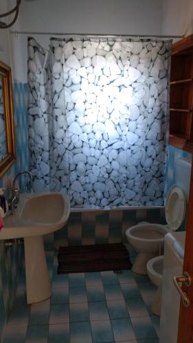 a bathroom with a sink and two toilets at Holiday Home Neochori in Neochori