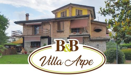 a house with a sign in front of it at Villa ARPE in Montemiletto
