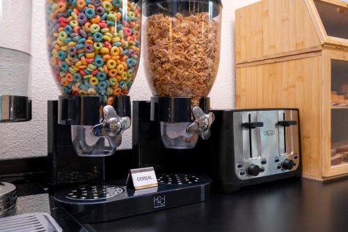 a counter top with two coffee makers and a microwave at SPOT X Hotel Orlando Intl Dr by The Red Collection in Orlando