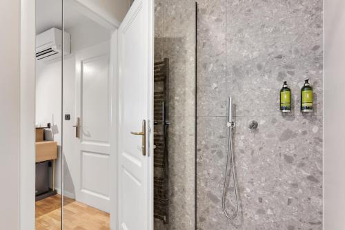 a bathroom with a shower with a glass door at Bloom Hotel in Ljubljana