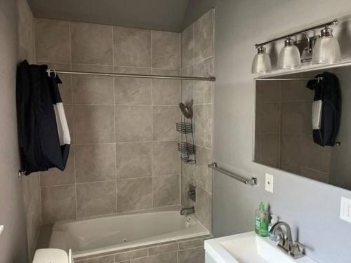 a bathroom with a tub and a sink and a shower at Gilcrease Hillside in Tulsa