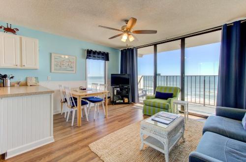 a kitchen and living room with a view of the ocean at 0601 Seaclusion by Atlantic Towers in Carolina Beach
