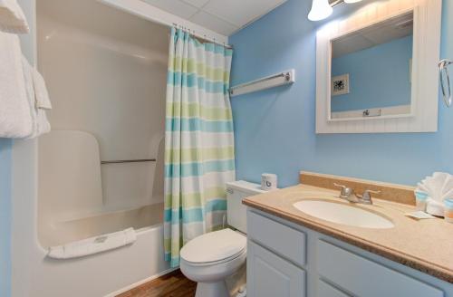 a bathroom with a sink and a toilet and a shower at 0601 Seaclusion by Atlantic Towers in Carolina Beach