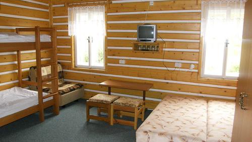 a bedroom with two bunk beds and a tv on the wall at Horska Bouda Dvoracky in Rokytnice nad Jizerou