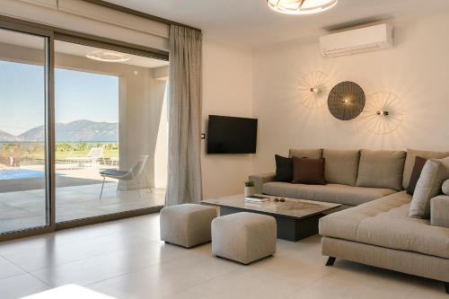 a living room with a couch and a table at Claire villa in Sami