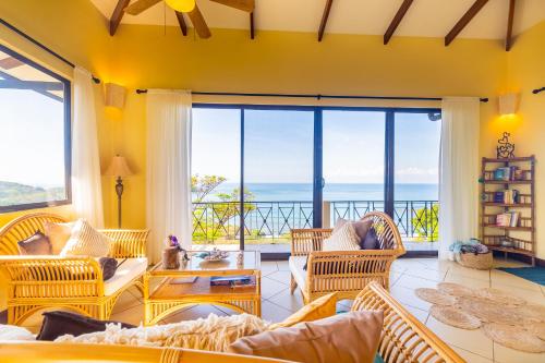 a living room with a view of the ocean at Villa Amor del Mar with Breathtaking View of Ocean & Jungle in Dominical