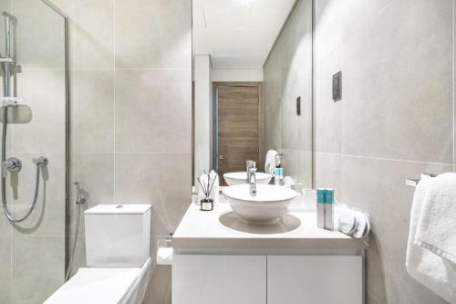 a bathroom with a sink and a toilet and a shower at Exquisite 1 BDR apt in the heart of Dubai Marina- Studio One Tower in Dubai