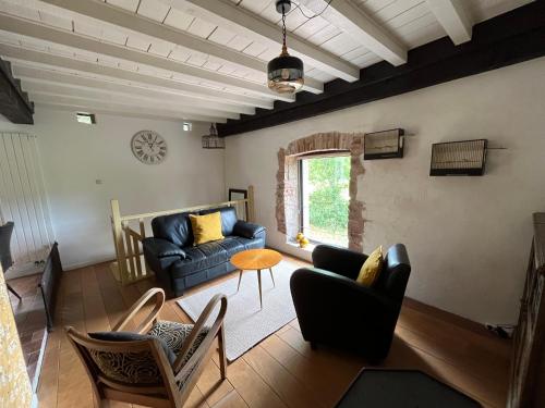 a living room with a blue couch and chairs at Le nid Mésange in Alligny-en-Morvan