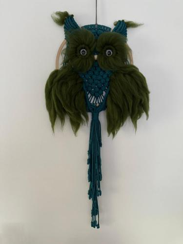 a blue owl ornament hanging on a wall at Mr. Sowa Sokolec in Ludwikowice Kłodzkie