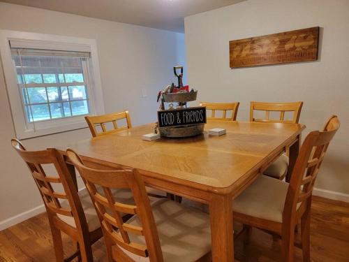 a wooden dining room table with chairs and a wine barrel on it at The Perfect Porch Retreat in Eufaula
