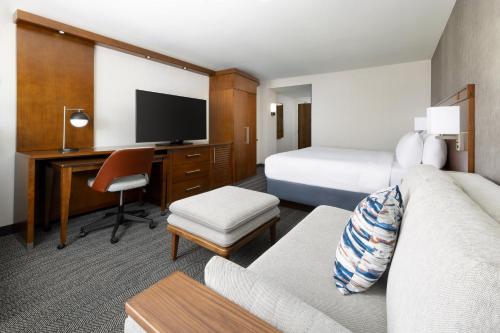 a hotel room with a bed and a desk at Courtyard by Marriott Los Angeles Woodland Hills in Woodland Hills