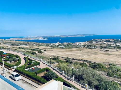 a view of a road and the ocean from a building at Twenty9th in Nadur