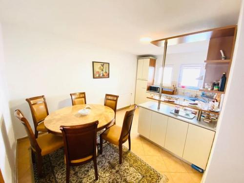 a kitchen and dining room with a table and chairs at Gërmia House - Prishtinë in Sofalija