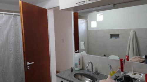 a bathroom with a sink and a large mirror at Centrico 07 in General Roca