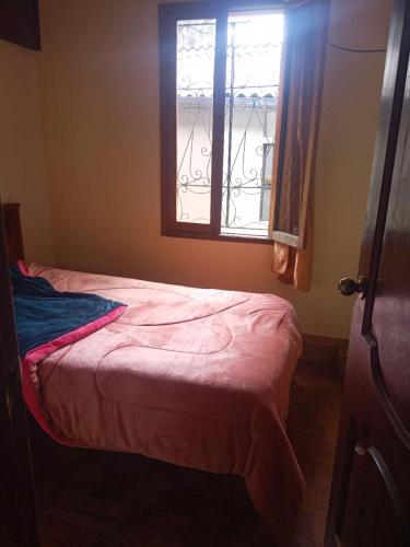 uma cama num quarto com uma janela em 悦来客栈 em Quito