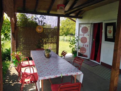 a table and chairs sitting on a patio at Blossom Cottage - Sustainable Tourism Retreat in Laktaši