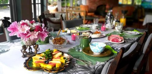 a table with plates of food and flowers on it at SCHUMANN'S RESORT & PARK in Alto Boquete