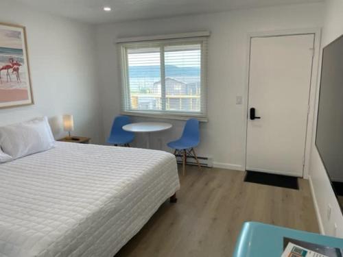 a bedroom with a bed and two chairs and a table at Single King Room in Lake City