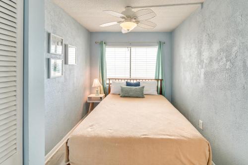 a bed in a bedroom with a ceiling fan at Cozy Coastal Condo with Airy Oceanfront Balcony in Myrtle Beach