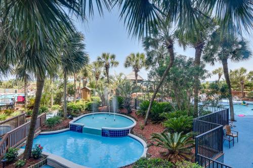 an image of a pool at a resort with palm trees at Oceanfront Condo with Views in North Myrtle Beach! in Myrtle Beach