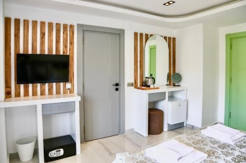 a living room with a flat screen tv on a wall at Stonehillkaş in Kas