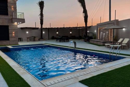 a swimming pool in the backyard of a house at Alhussam Villa & Chalet - Dead Sea in Al Rama