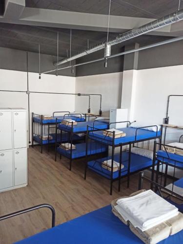 a row of blue bunk beds in a room at Albergue HR in Sarria