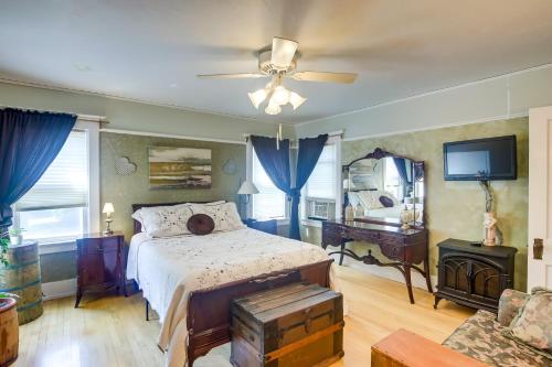 a bedroom with a bed and a ceiling fan at Algoma Victorian - Steps to Lake Michigan! in Algoma