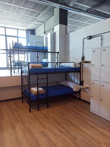 a room with three bunk beds in a building at Albergue HR in Sarria