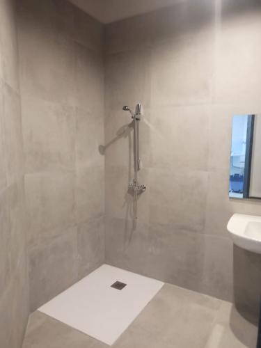 a bathroom with a shower and a sink at Albergue HR in Sarria