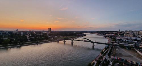 a view of a river with a bridge and a city at Beograd na vodi - Belgrade Waterfront Riverside in Belgrade