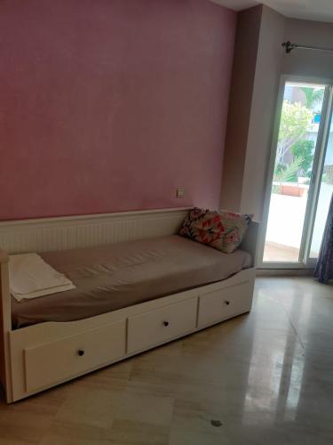 a bed sitting in a room with a window at Lux furnished flat Enjoy ur stay in Nouaceur