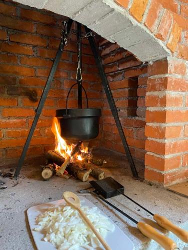 a pot over a fire in a brick oven at Villa Rivus in Sarajevo