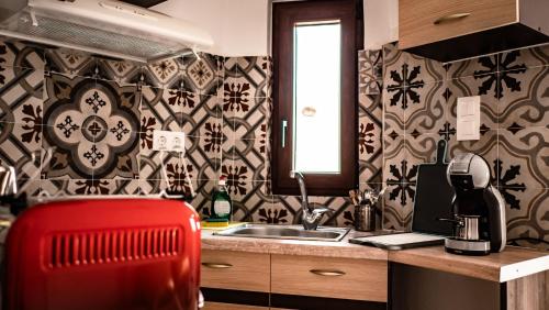 a kitchen with a red chair in front of a sink at Mitato Eagle's Nest Asfentamos in Níthavris