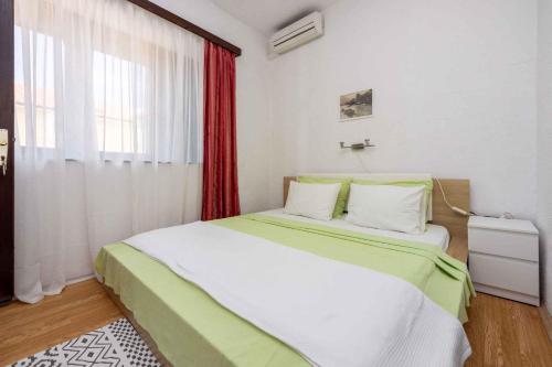 a bedroom with a large bed and a window at Apartment in Selce 5803 in Selce