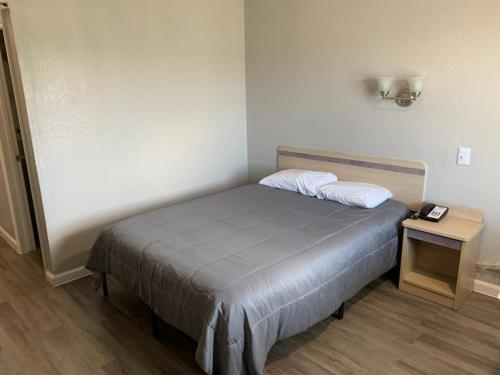 a small bedroom with a bed and a table at Loyalty Inn Columbus in Brice